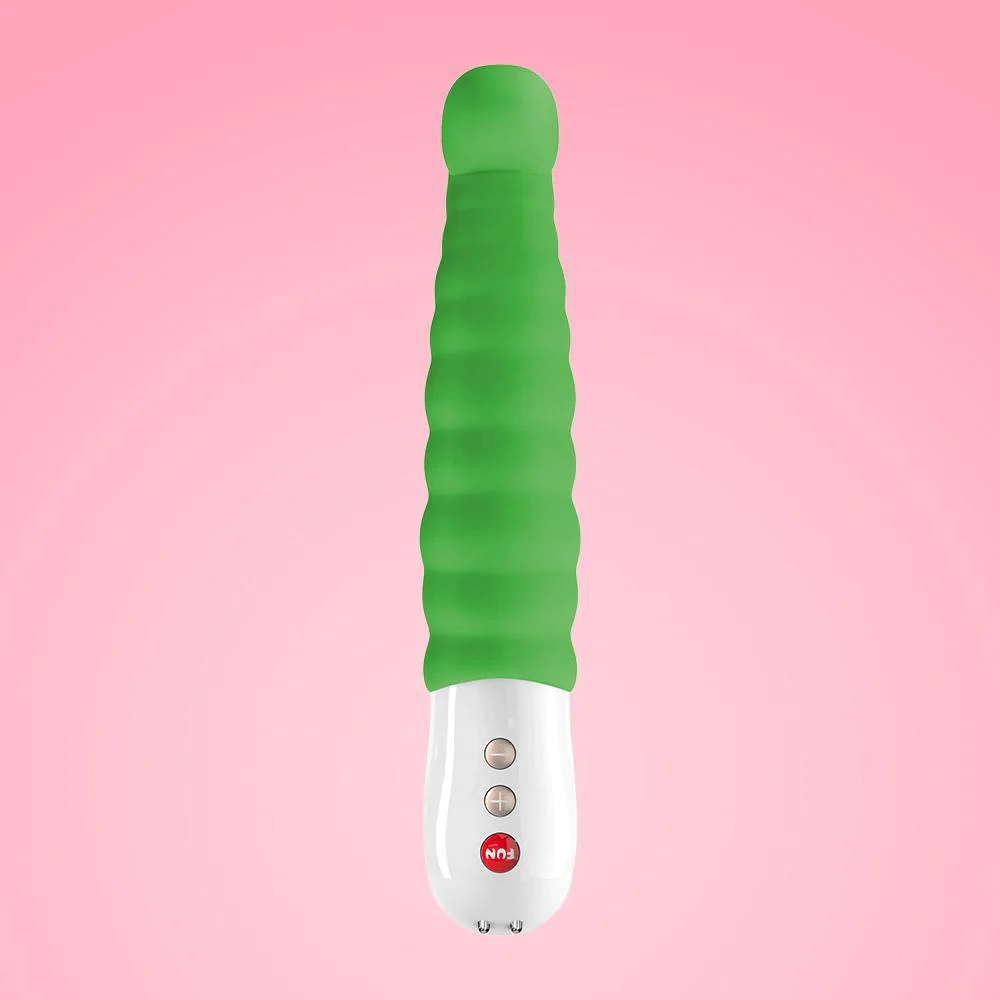 Green vibrator against a soft pink background